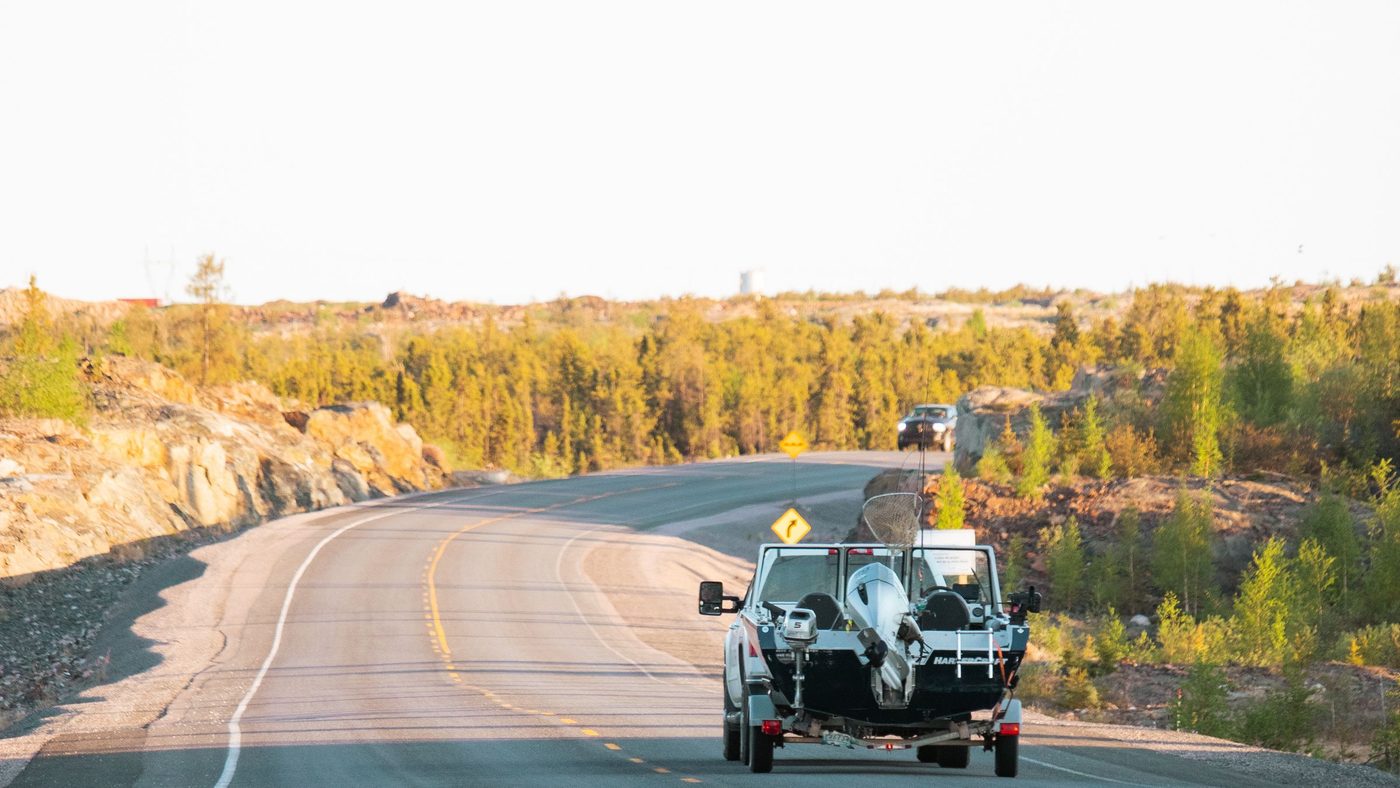 Pickup truck towing an aluminium fishing boat on a trailer